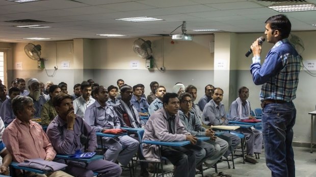 Auto-rickshaw drivers listen during a gender training session at Ashok Leyland Driver Training Institute in north Delhi.