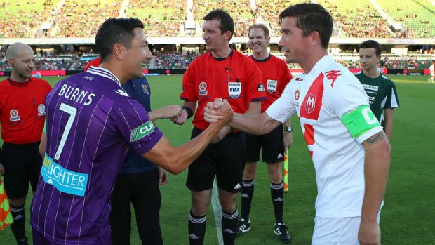 Jacob Burns (left) shakes hands with Harry Kewell before the match.