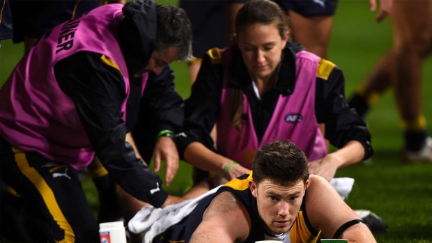 PERTH, AUSTRALIA - AUGUST 8: Jeremy McGovern of the West Coast Eagles is worked on by the physics at three quarter time during the 2015 AFL round 19 match between the West Coast Eagles and the Hawthorn Hawks at Domain Stadium, Perth, Australia on August 8, 2015. (Photo by Daniel Carson/AFL Media/Getty Images)