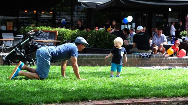 Michael Lyden of Bruce plays on the grass with his son Jacob, 18 months, at Green Square, Kingston.