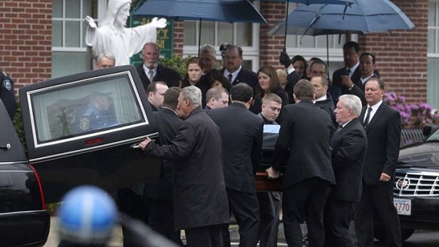 Loved ones mourn: Pallbearers carry the casket of fallen police officer Sean Collier.