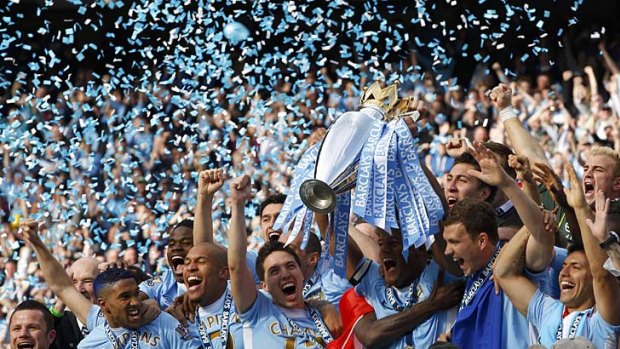 Party time: Manchester City captain Vincent Kompany lifts the Premier League trophy after his side scored two injury-time goals to beat Manchester United to the title.