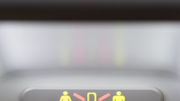The lavatory sign on a Boeing 737-700 showing that it is occupied.
