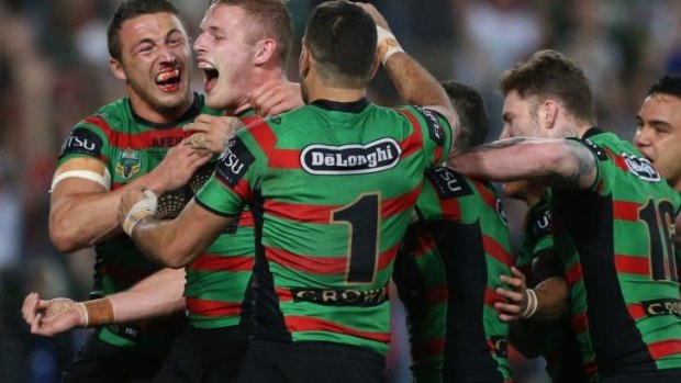 Brothers in arms: The Rabbitohs celebrate George Burgess' try which opened the floodgates.