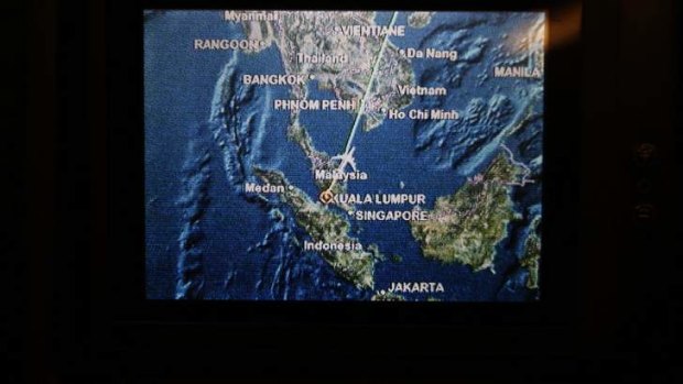 A screen on board Malaysia Airlines Boeing 777-200ER flight MH318 shows the plane's flight path as it cruises over the South China Sea from Kuala Lumpur towards Beijing, at approximately the same point when, on March 8, flight MH370 lost contact with air traffic controllers.