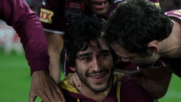 Anguish eased ... an injured Johnathan Thurston with teammates after their Origin victory on Wednesday night.