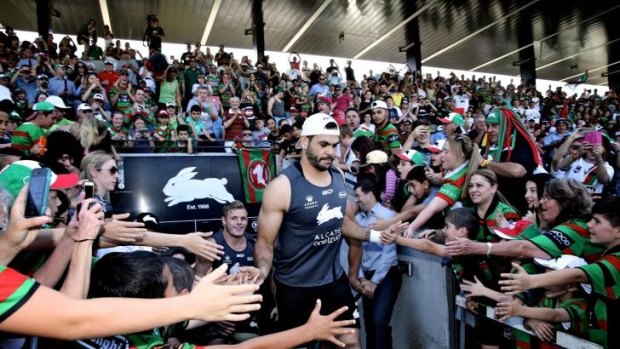 Glory, glory to South Sydney: Greg Inglis is greeted by a big group of supporters at the club's fan day on Monday.