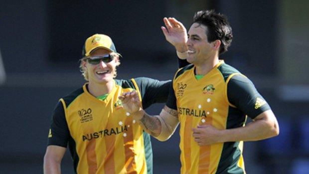 Shane Watson (left) and Mitchell Johnson celebrate the wicket of Mohammad Hafeez.