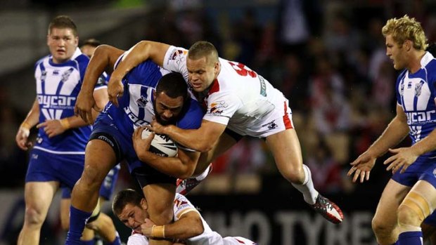 All aboard &#8230; St George Illawarra's Mitch Rein and Dan Hunt hang on as the heaviest man in NRL at 133kg, Canterbury's Sam Kasiano, gathers a head of steam on the way to helping the Bulldogs win in Wollongong.