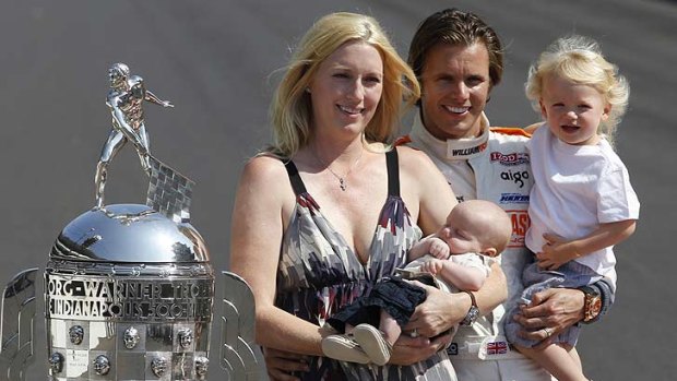 Wheldon with his wife Susie, with son Oliver, left, and Sebastian, right, pose with the  Borg-Warner Trophy in May.
