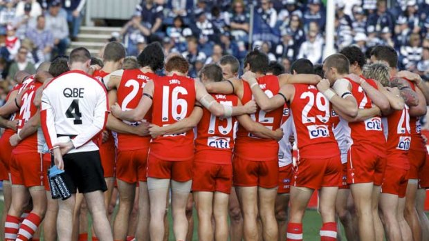 Sydney players form a huddle in honour to co-captain Jarrad McVeigh, whose baby daughter died this week, before their match against Geelong at Skilled Stadium.