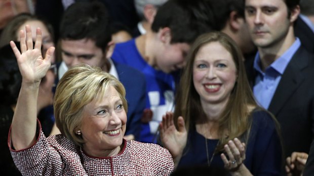 Democratic presidential candidate Hillary Clinton waves to supporters as she enters the room with daughter Chelsea.