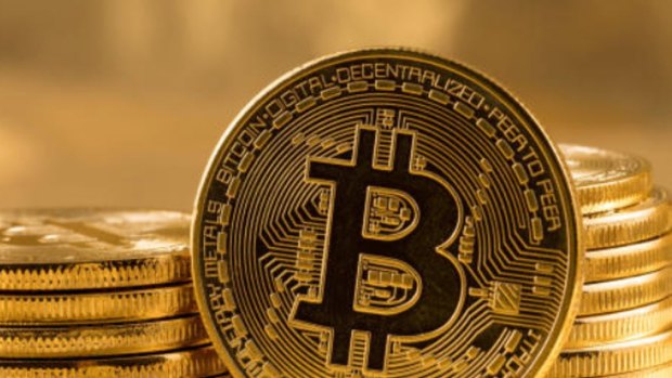 Bitcoin / Bitcoins. Generic. Photo by?Steve Heap. Stack of bitcoins with gold background with a single coin facing the camera in sharp focus with shading on the icon letter B on the face of the bit coin. Stock photo ID: 616226957