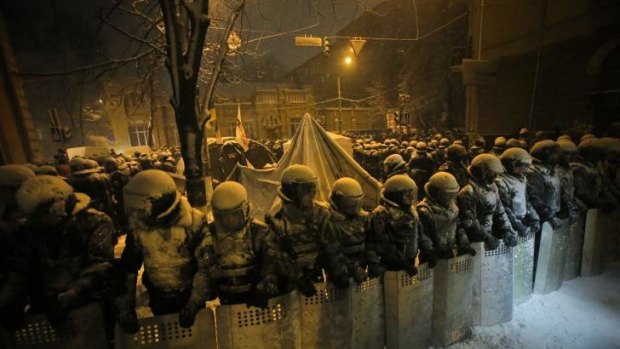 Ukrainian riot police block Pro-European Union activists' tent camp next to the Ukrainian Government buildings in Kiev.