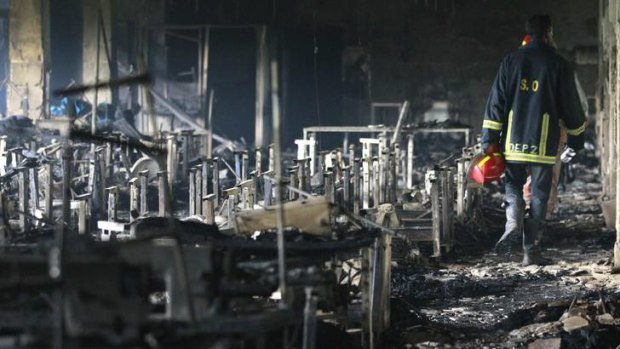 A firefighter inspects a garment factory after a blaze in Savar.
