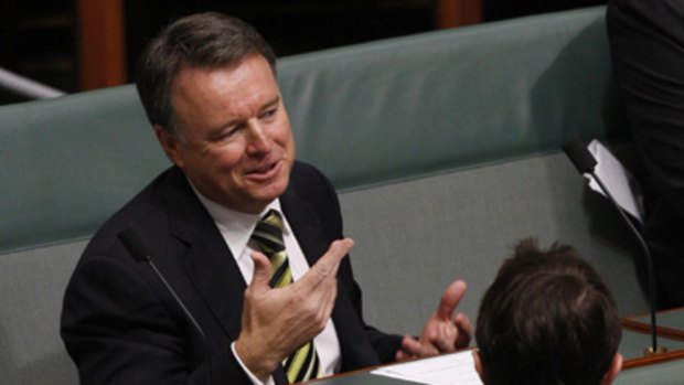 Joel Ftizgibbon takes his seat on the backbench during Question Time today after resigning as Defence Minister.