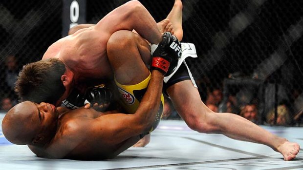 Chael Sonnen (top) gets the upper hand in the first round of his UFC middleweight title bout against champion Anderson Silva, who went on to score a TKO victory in the second round.