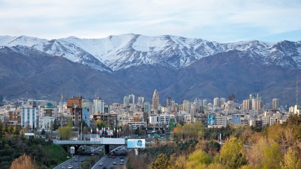 Tehran skyline in front of snow covered Alborz Mountains, Iran.