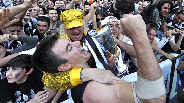 Darren Jolly in happier Magpie times, with Joffa and exultant Collingwood fans after the 2010 premiership triumph.