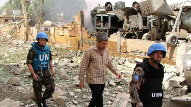 Members of the UN Supervision Mission in Syria inspecting the site of a blast in the eastern city of Deir Zor on May 19.