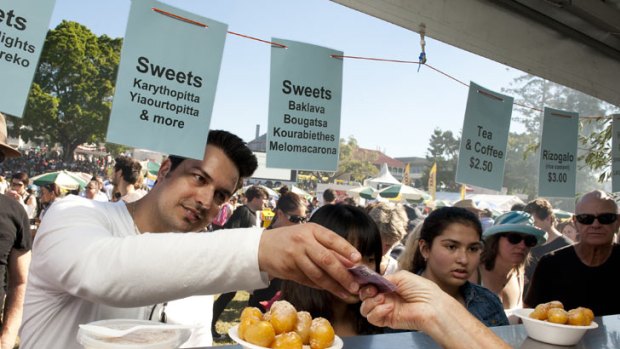 A man pays for honey puffs at Paniyiri, Australia's longest running Greek Festival, held at Musgrave Park in Brisbane on May 19, 2012.
