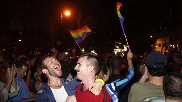 People celebrate after the New York Senate passed a bill legalizing gay marriage in New York.