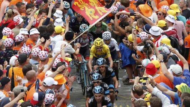 Crowd crush: Team Sky escort race leader Christopher Froome of Great Britain up Alpe d'Huez.G)