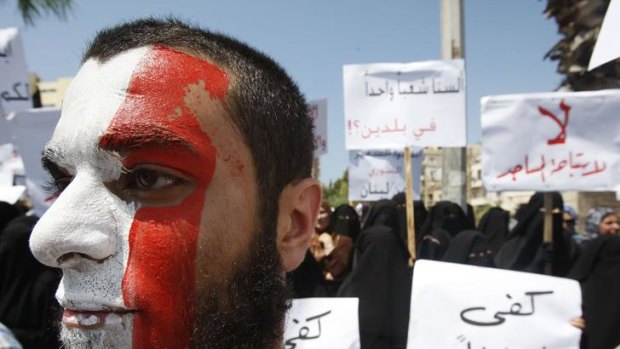 A member of a Sunni group, painted in Syria's national colours, takes part in a protest in Lebanon against Syrian president Bashar al-Assad.
