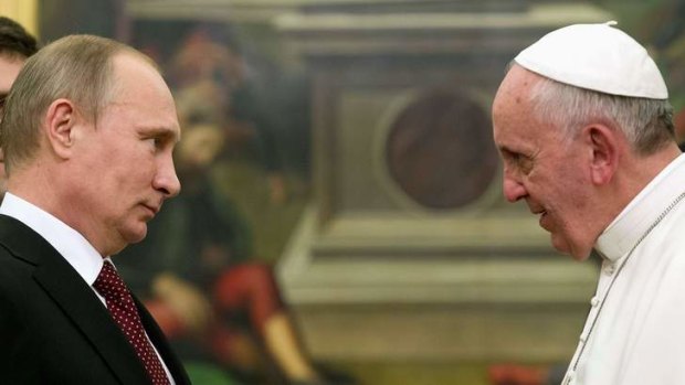 Vladimir Putin meets Pope Francis during a private audience at the Vatican.