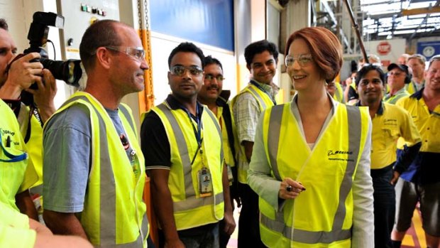 Alert in yellow ... Julia Gillard during a visit yesterday to Boeing Aerostructures in Port Melbourne. Ms Gillard said: ''Whilst ever Labor is here, we will be making cars here in Australia.''