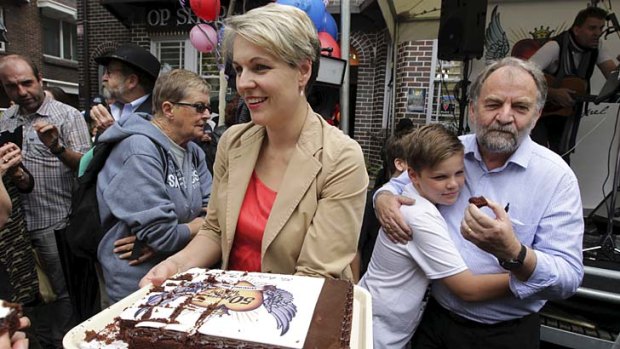 Cake and care: Tanya Plibersek hands out the birthday cake at a street party with Wayside Chapel chief executive Reverend Graham Long.