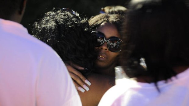 Looking for answers ... Teresa Carter, mother of Chavis Carter, is hugged by supporters following a candlelight vigil.