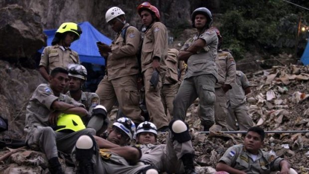 Made contact with three workers: Rescuers gather outside the mine where 11 workers are trapped.