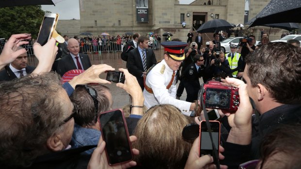 Prince Harry meets the crowd who braved wet weather outside the Australian War Memorial.