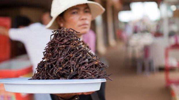 Cambodian charm: Deep-fried spiders tempt passing truckers.
