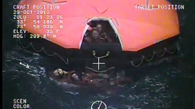 A crewman from the replica tall ship HMS Bounty is aided in the water by a member of the US Coast Guard next to a life raft in the Atlantic Ocean off North Carolina. The ship was sunk in high seas brought by Hurricane Sandy.