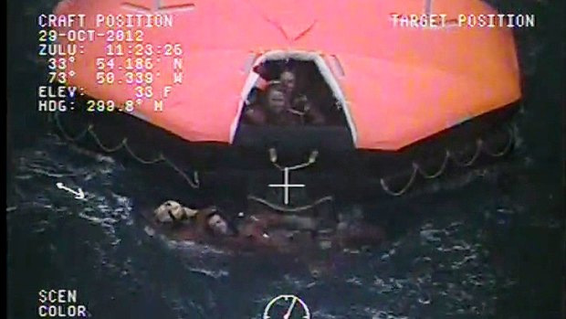 Nightmare scenario ... A crewman from the replica tall ship HMS Bounty is aided in the water by a member of the US Coast Guard as passengers and crew shelter in a life raft in the Atlantic Ocean off North Carolina. The ship was sunk in high seas brought by Hurricane Sandy.