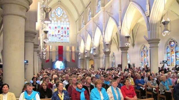 Worshippers join the service for the canonisation of Mary MacKillop at St Stephen's Cathedrial, Brisbane.