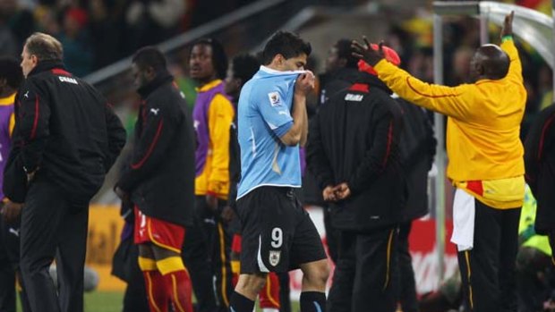 Luis Suarez leaves the pitch after his red card against Ghana.