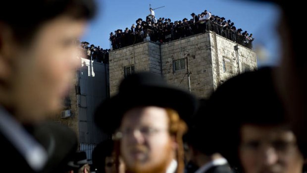 Orthodox Jews gather to watch the funeral procession of Rabbi Ovadia Yosef in Jerusalem.