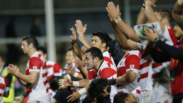 Japan players wave to the crowd after the Rugby World Cup Pool B match between USA and Japan at Kingsholm, Gloucester, England, Sunday, Oct. 11, 2015. Japan won the match 18-28. (AP Photo/Frank Augstein)