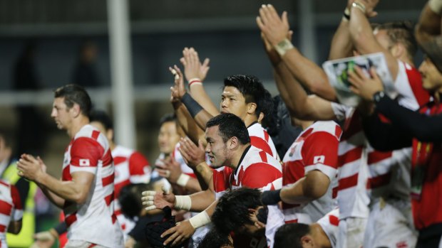 Feelgood story: Japan players wave to the crowd after the Rugby World Cup Pool B match between USA and Japan at Kingsholm, Gloucester.