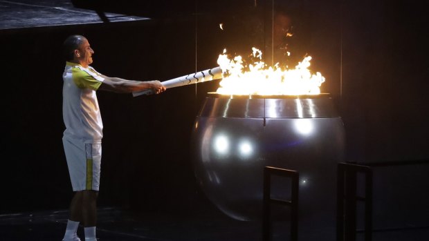 Vanderlei de Lima lights the Olympic flame during the opening ceremony.