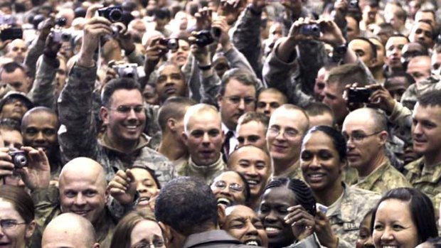 Hail to the chief ... Barack Obama, in a leather jacket, greets US troops at Bagram Air Base in Afghanistan.