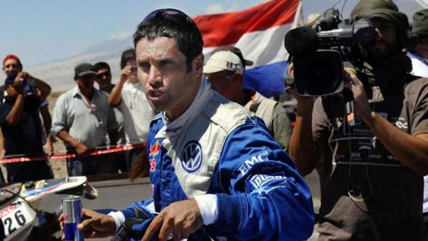 Nasser al-Attiyah has some refreshments at the end of stage 10.