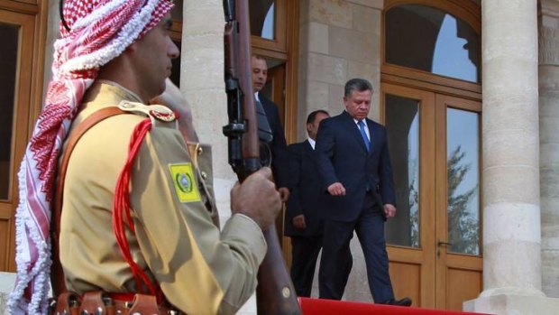 King Abdullah (right) leaves after the swearing-in ceremony for the new cabinet at the Royal Palace in Amman.
