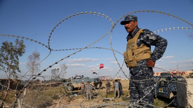 Iraqi security forces prepare to attack Islamic State positions in Tikrit on Thursday. 