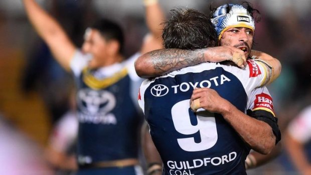 Home and dry: The Cowboys celebrate after Johnathan Thurston's golden-point field goal.