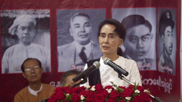 Myanmar opposition leader Aung San Suu Kyi speaks during a ceremony to mark the 68th anniversary of Martyrs' Day at the headquarters of her National League for Democracy party in front of the portraits of independence heroes in Yangon, Myanmar.