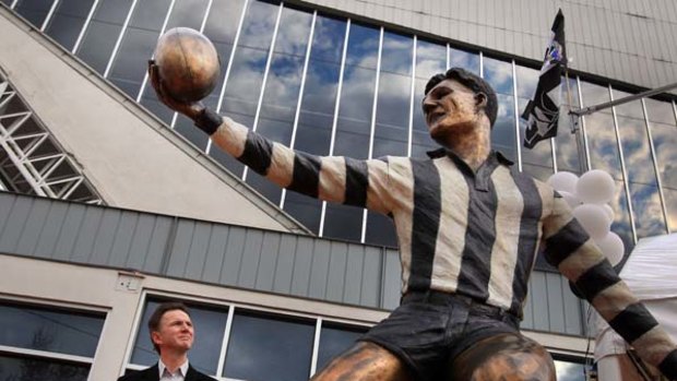 Peter Rose, son of legend Collingwood player Bobby Rose at the statue of his father at the Westpac Centre.
